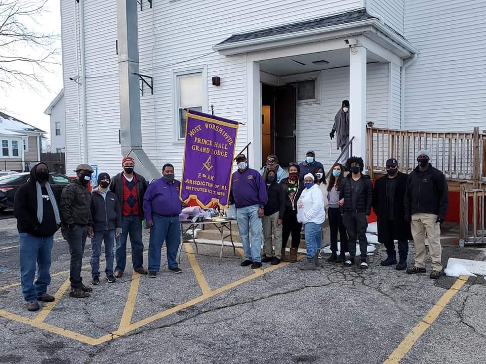 A group of people standing in front of a building.