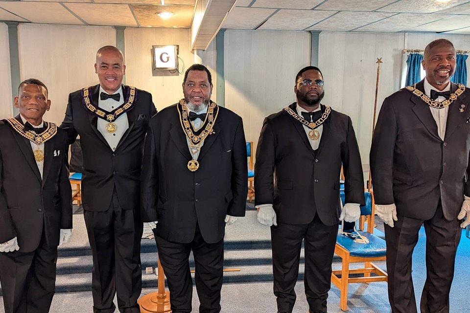 A group of men in suits and ties standing next to each other.