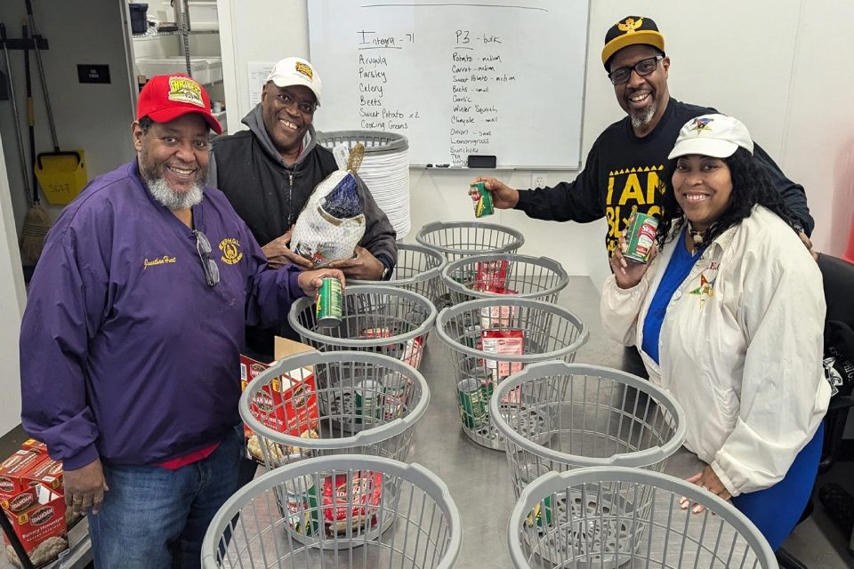 A group of people standing around baskets filled with cans.