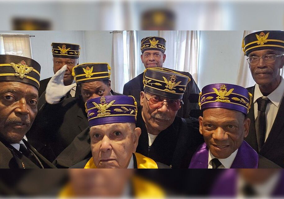 A group of men wearing purple and yellow hats.