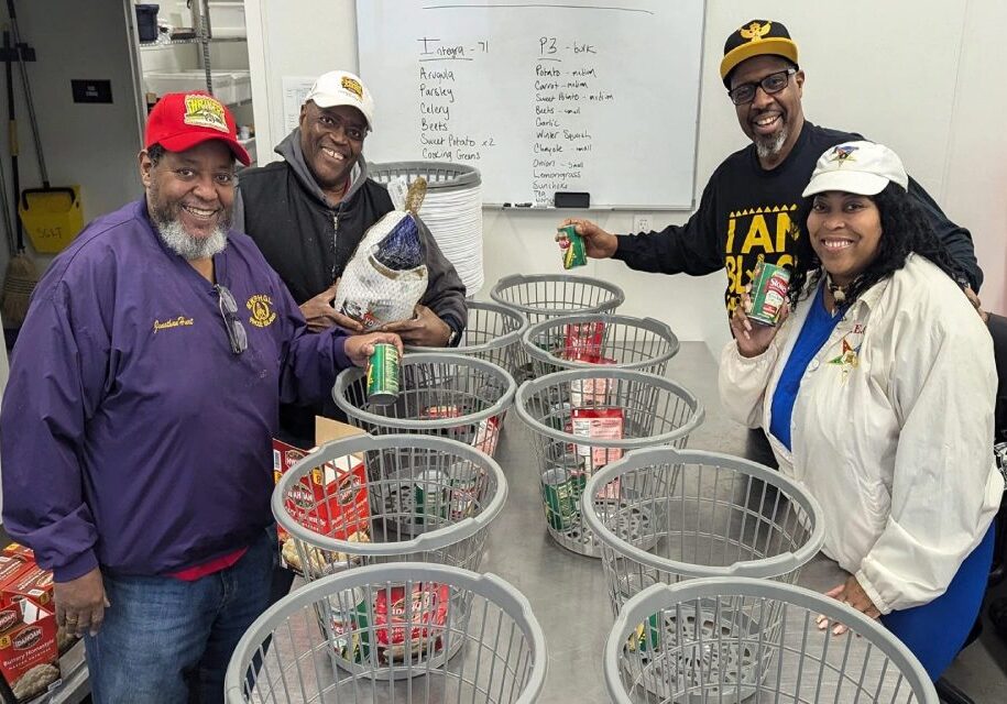 A group of people standing around baskets filled with cans.