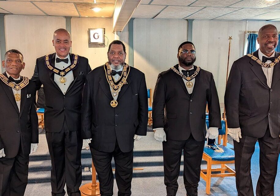 A group of men in suits and ties standing next to each other.